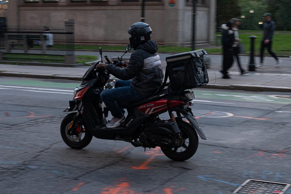 An e-bike delivery driver on Tremont St. on Wednesday, October, 8th, 2025. (Nick Peace/ Beacon Staff)
