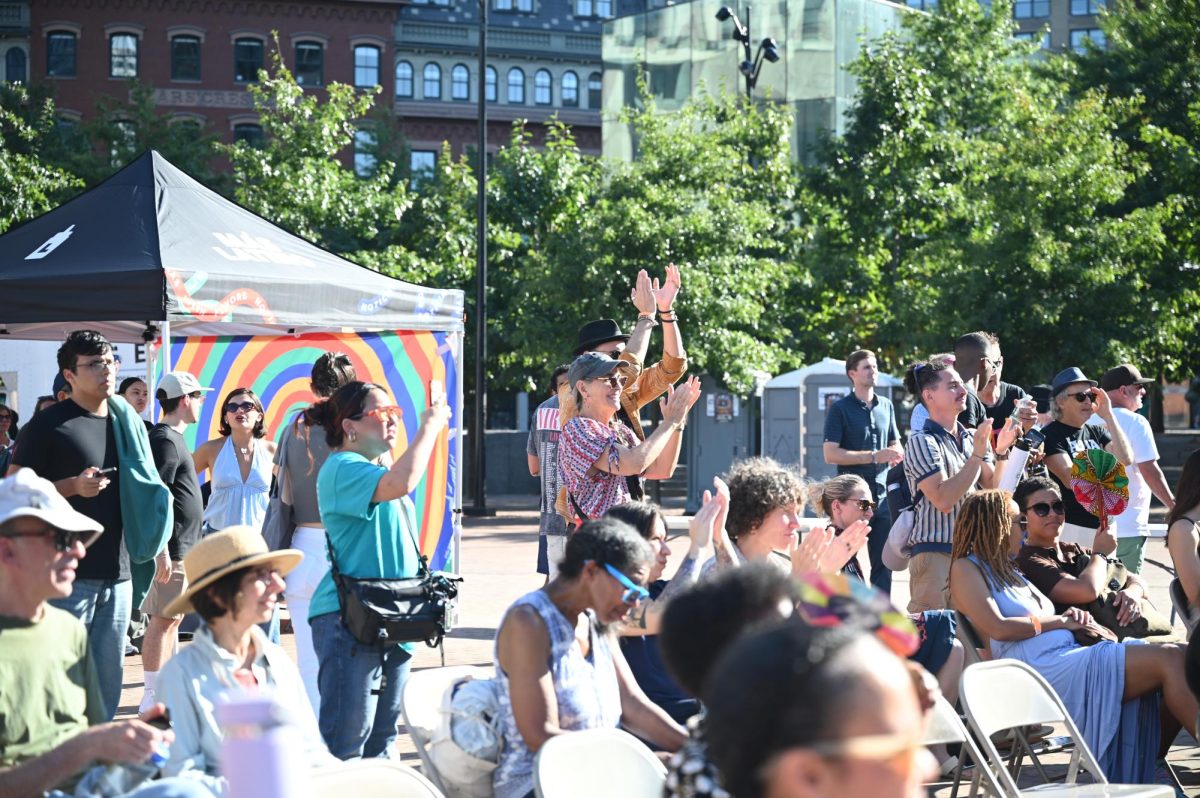 Attendees clap along as they watch musical performances during Fiesta en la Plaza, a Latinx Heritage Month celebration in City Hall Plaza on Sunday, Sept. 28, 2025. (Pranati Kotamraju / Beacon Correspondent)