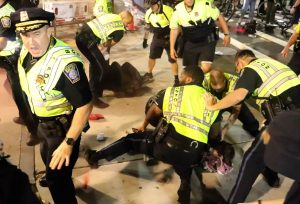 Pro-Palestine protesters are held down and arrested following a demonstration on Tuesday, Oct. 7, 2025. (Bryan Hecht / Beacon Staff)