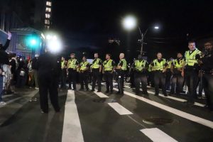 Officers form a blockade preventing protesters from crossing Tremont Street while others are arrested after a Pro-Palestine protest on Tuesday, Oct. 7, 2025. (Bryan Hecht / Beacon Staff)