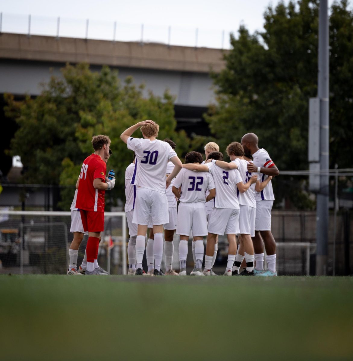 The Emerson men's soccer team huddles during their match against Wheaton College on Sept. 27, 2025 (Jacob Goldberg/ Beacon Staff).