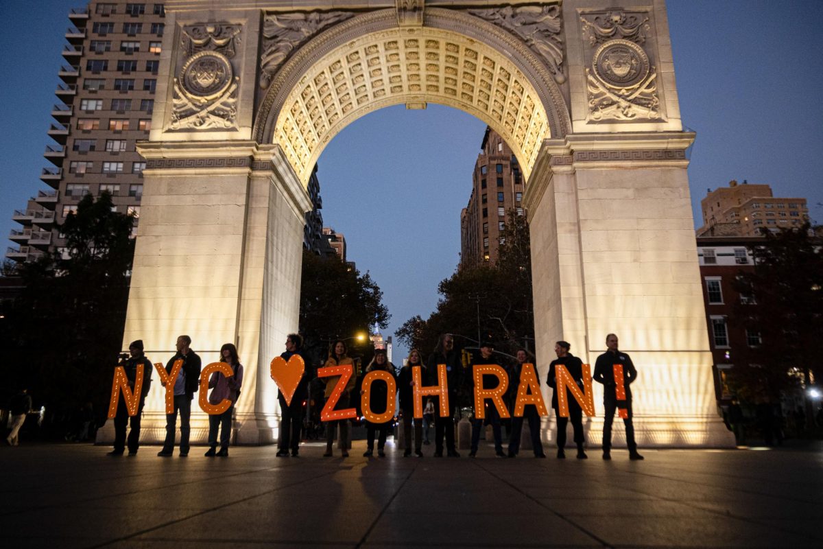 A group of people hold up letters that spell out Zohran in Washington Square Park Tuesday evening. (Nick Peace/ Beacon Staff)
