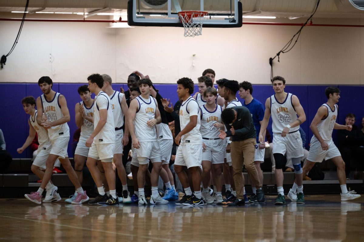The Emerson men's basketball team breaks its huddle against the Salem State University Vikings on Nov. 11, 2025 (Riley Goldman/ Beacon Staff/ Archive).