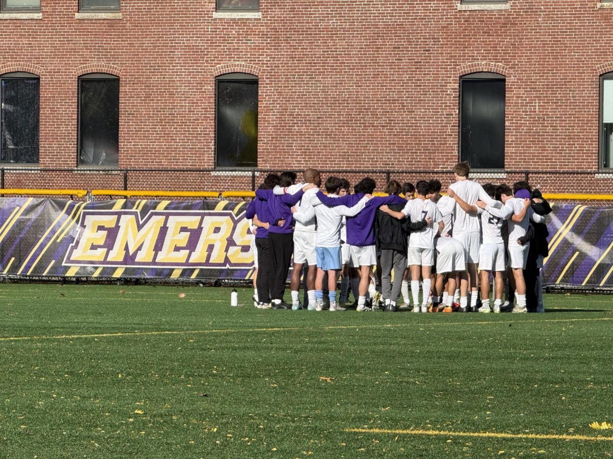 The Emerson men's soccer team huddles prior to their first-round postseason matchup against the WPI Engineers on Nov. 4, 2025 (Jordan Pagkalinawan/ Beacon Staff).