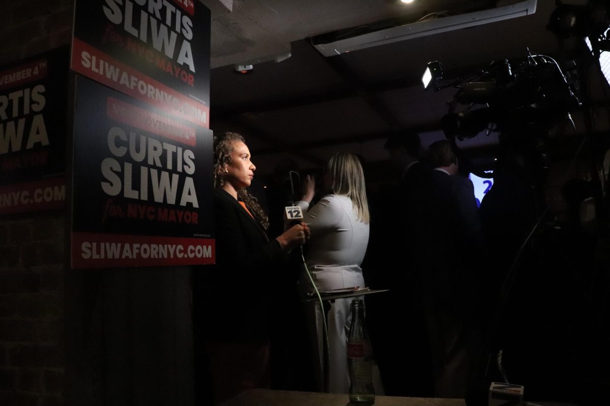 A reporter prepares for the arrival of Curtis Sliwa to his election night even at Arte Cafe in Manhattan on election night, Tuesday, Nov. 4, 2025. (Bryan Hecht / Beacon Staff)