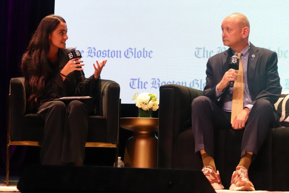 Diti Kohli '21 (left) a reporter with The Boston Globe business desk, talks with Assumption University President Greg Weiner (right) during a panel discussion on higher education at The 2025 Boston Glove Summit on Tuesday, Nov. 18, 2025. (Bryan Hecht / Beacon Staff)