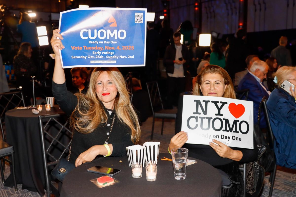 Supporters hold signs at Cuomo election night watch party HQ. (Arthur Mansavage/ Beacon Staff)