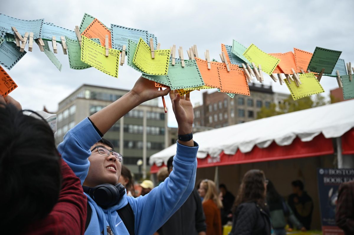 An attendee hangs up a poem at the annual Boston Book Festival in Copley Square on October 25, 2025. (Courtesy Maddy Jimiera)