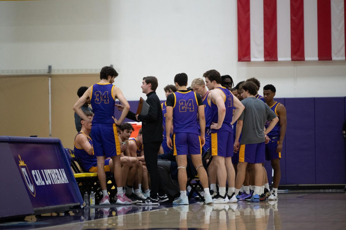 The Emerson men's basketball team huddles during a timeout against Cal Lutheran University on Dec. 19, 2025 (Riley Goldman/ Beacon Staff/ Archive).