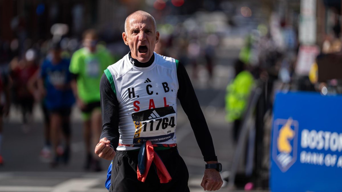 A runner gives a triumphant gesture as they approach the finish line of the 130th Boston Marathon on Monday, April 20, 2026. (Alex Cuozzo/Beacon Staff)